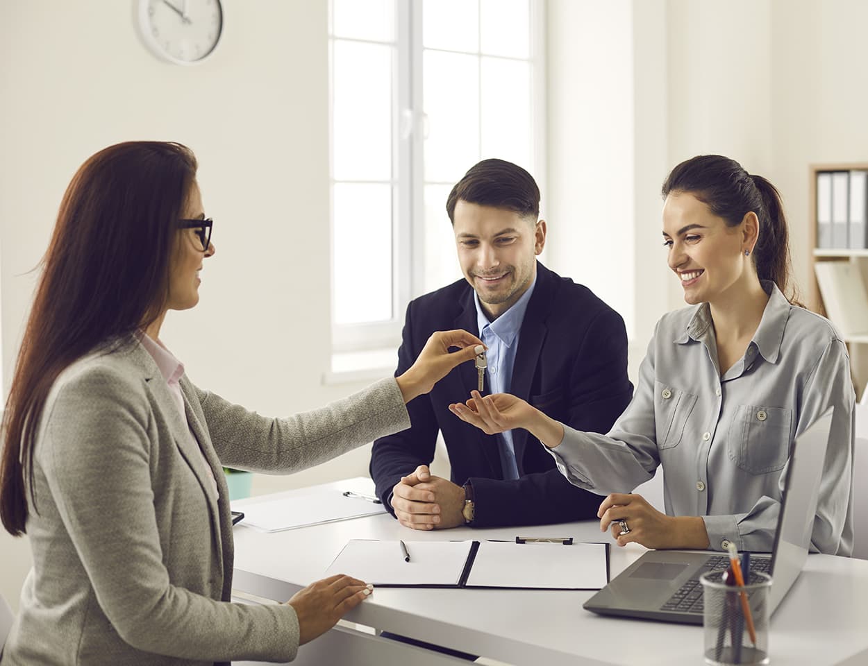 Agent handing keys to happy couple